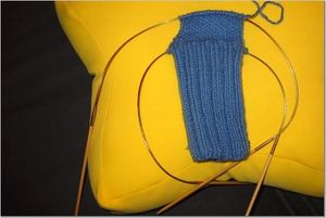 Knitting a sock using two circular needles.