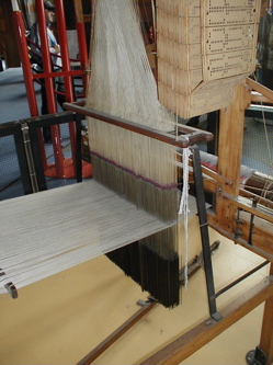 Close-up view of comber board, harness, mails, weights (Lings)and warp with 1040 ends