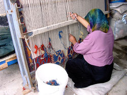 A Turkish woman in Konya works at a traditional loom. Vertical looms were probably the first to be invented.